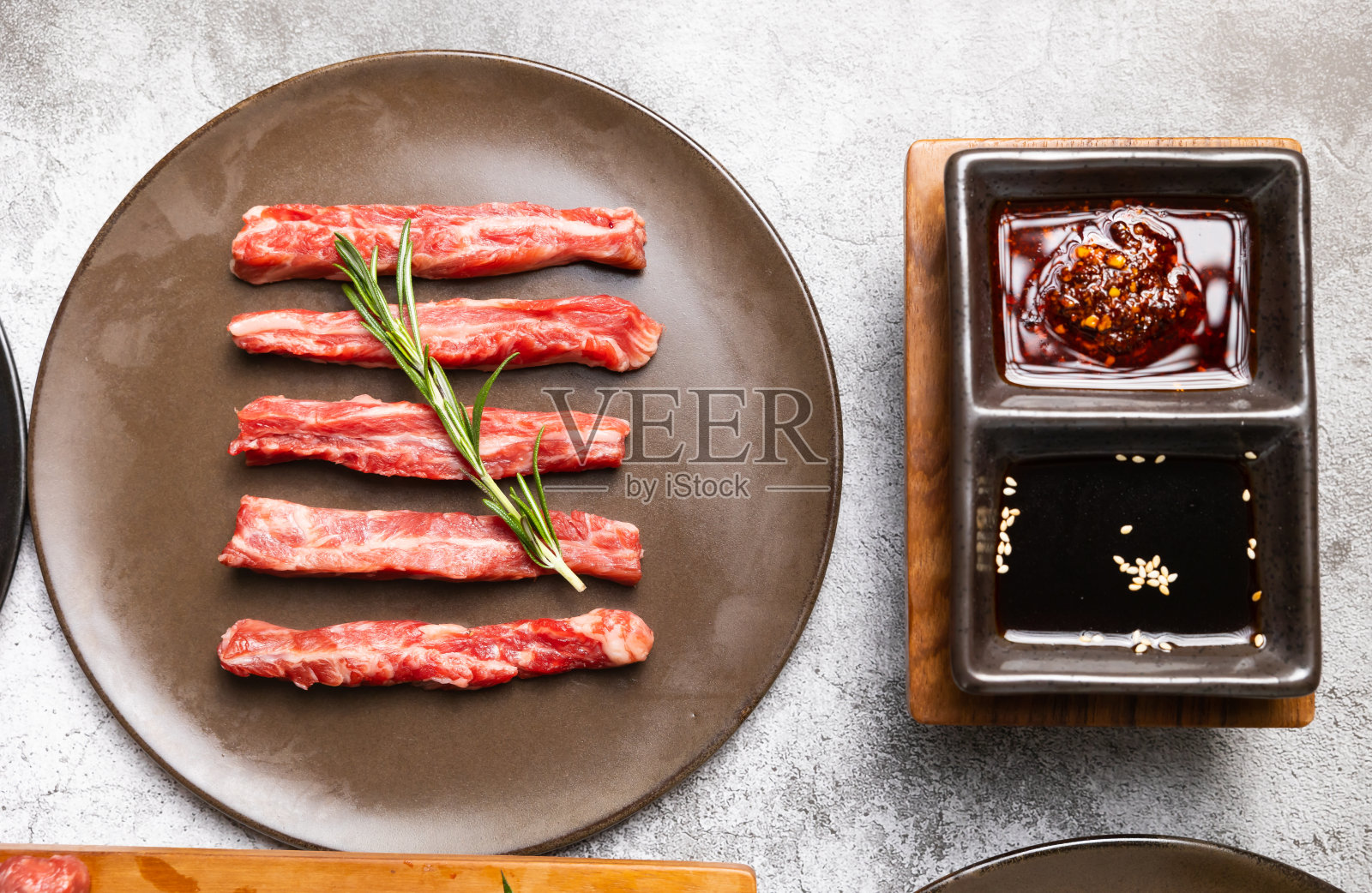 日本和韩国食品隔离在灰色的石头横幅背景俯视图品种新鲜的生牛肉牛排盘烧烤。辣椒和香草照片摄影图片