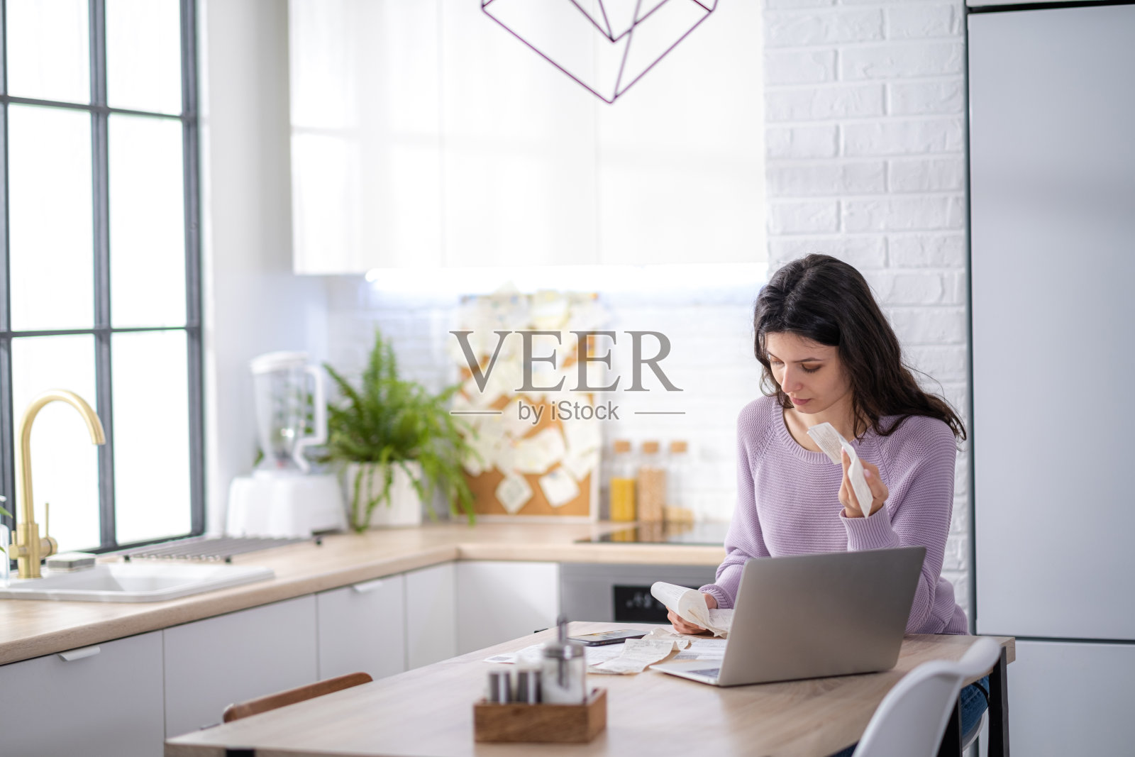 节俭的女性在家用手机计算,上网在小工具上纳税,节俭的女性在电话上计算财务支出,管理计划家庭家庭预算照片摄影图片