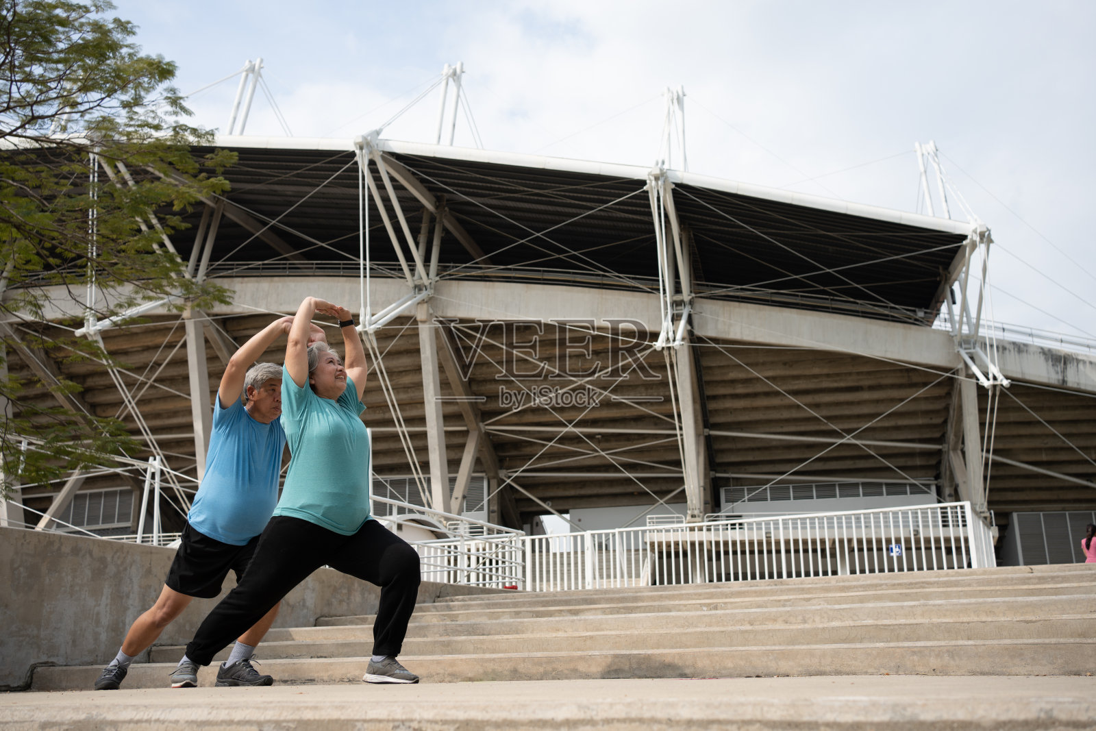 亚洲的老年夫妇在早晨进行户外运动之前,会穿上运动服,热身肌肉。幸福老人户外生活理念,全程活跃幸福老人家庭夫妻照片摄影图片