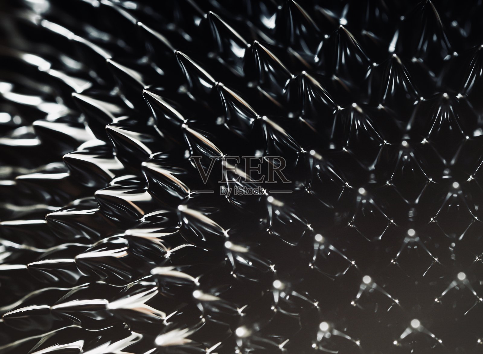 磁性液体尖峰。对磁场起反应的铁磁流体。照片摄影图片