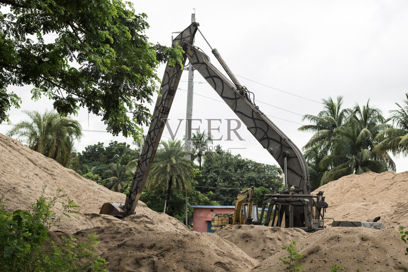 挖掘机在地面作业,挖掘机在排土场作业,挖掘机在工业区作业照片摄影图片