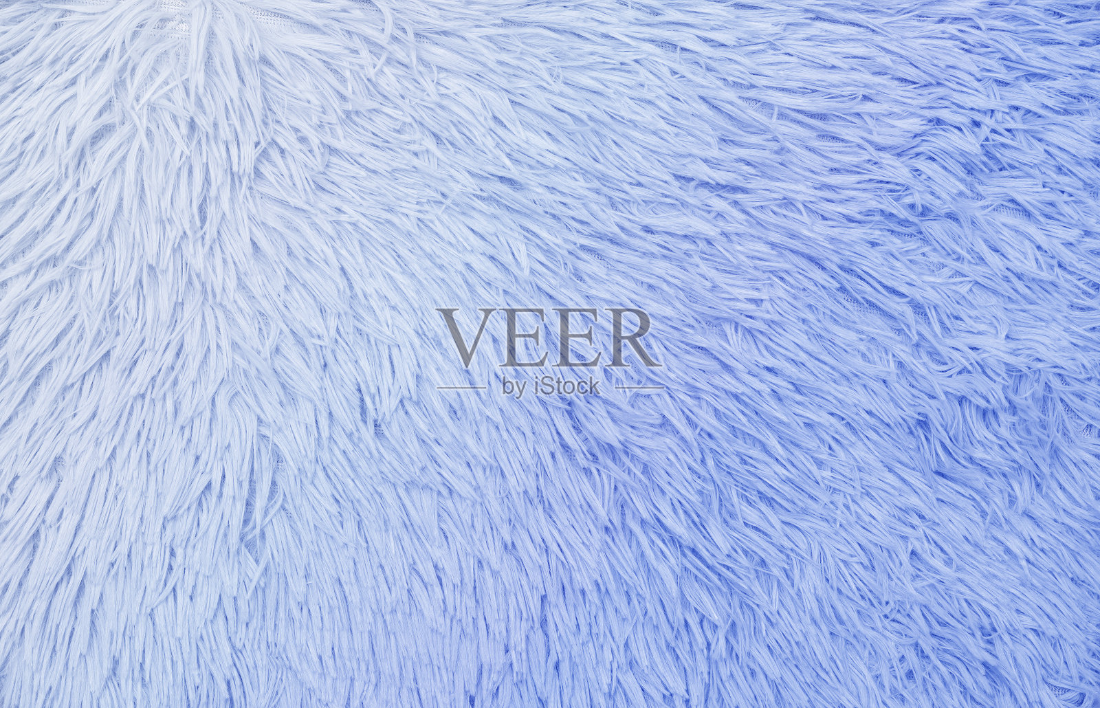 柔软的蓝蓝色渐变羊毛地毯。适合作文字或产品的背景。照片摄影图片