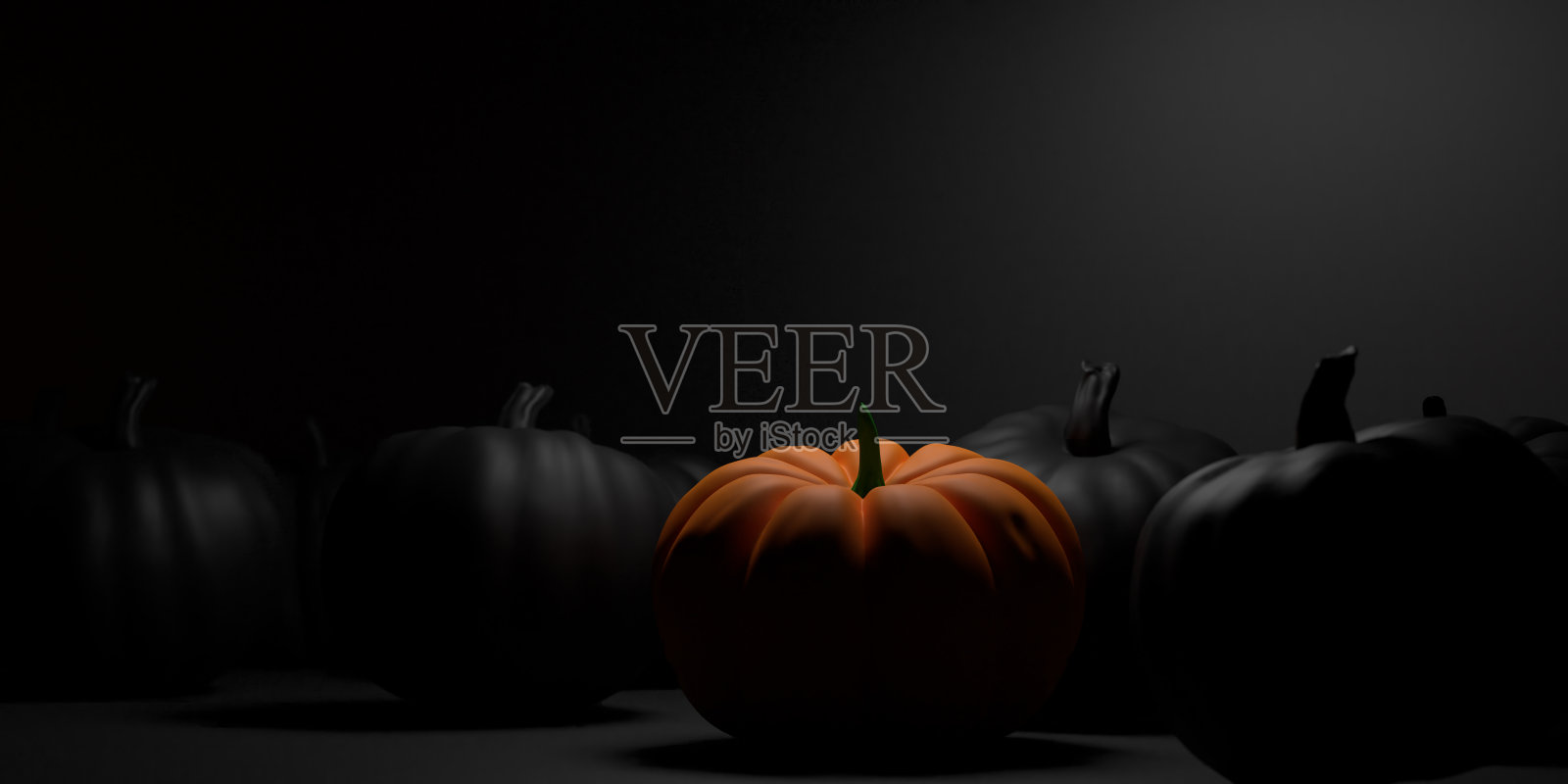 光线落在黑色背景的南瓜上照片摄影图片