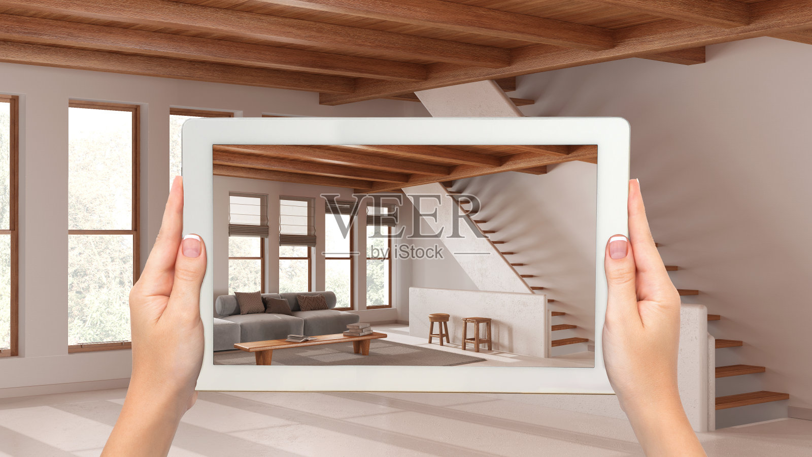 增强现实概念。手持平板电脑与AR应用程序用于模拟家具和设计产品在空的木制室内,最小的客厅与楼梯照片摄影图片