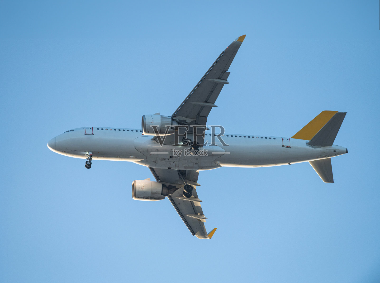 一架客机着陆。客机在空中飞行。飞机打开起落架。照片摄影图片