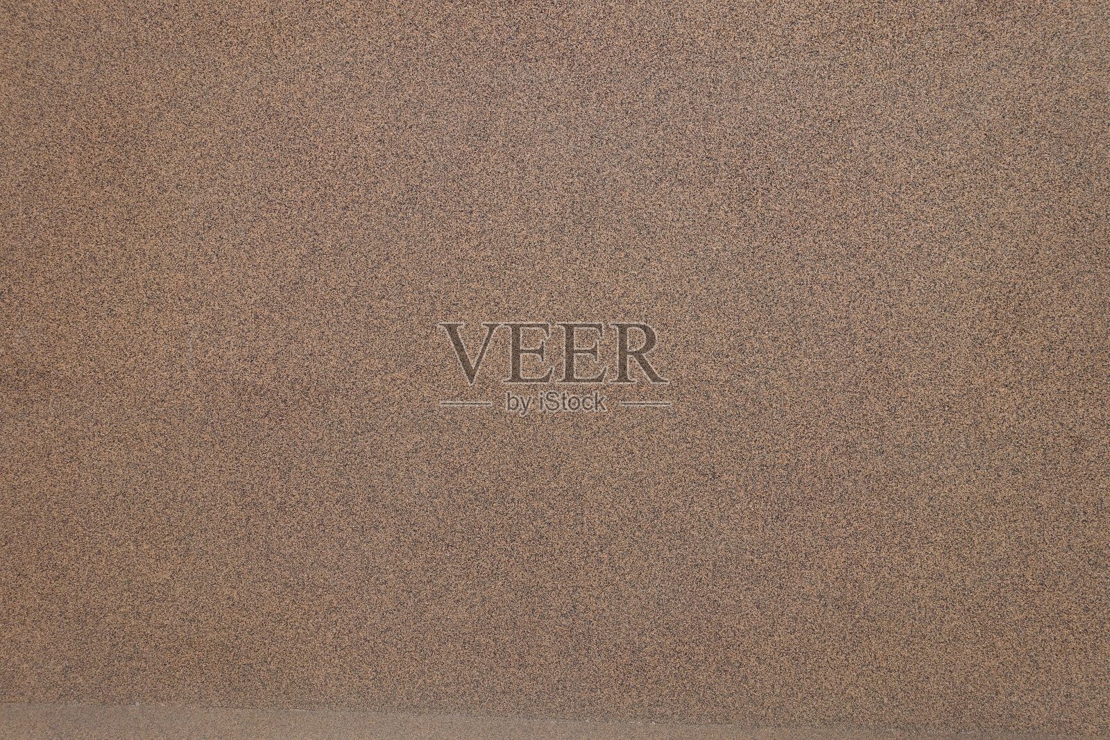 墙壁带有粗糙的棕色和黑色鹅卵石饰面纹理照片摄影图片