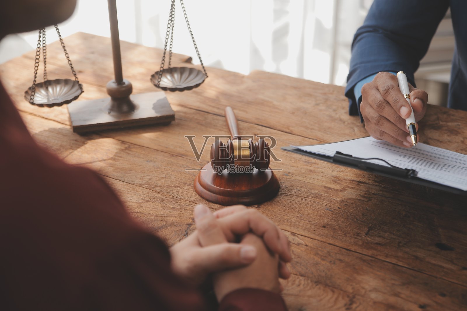 正义与法律概念。法律顾问在后台用木槌和法律或法律团队会议向客户出示签署的合同照片摄影图片