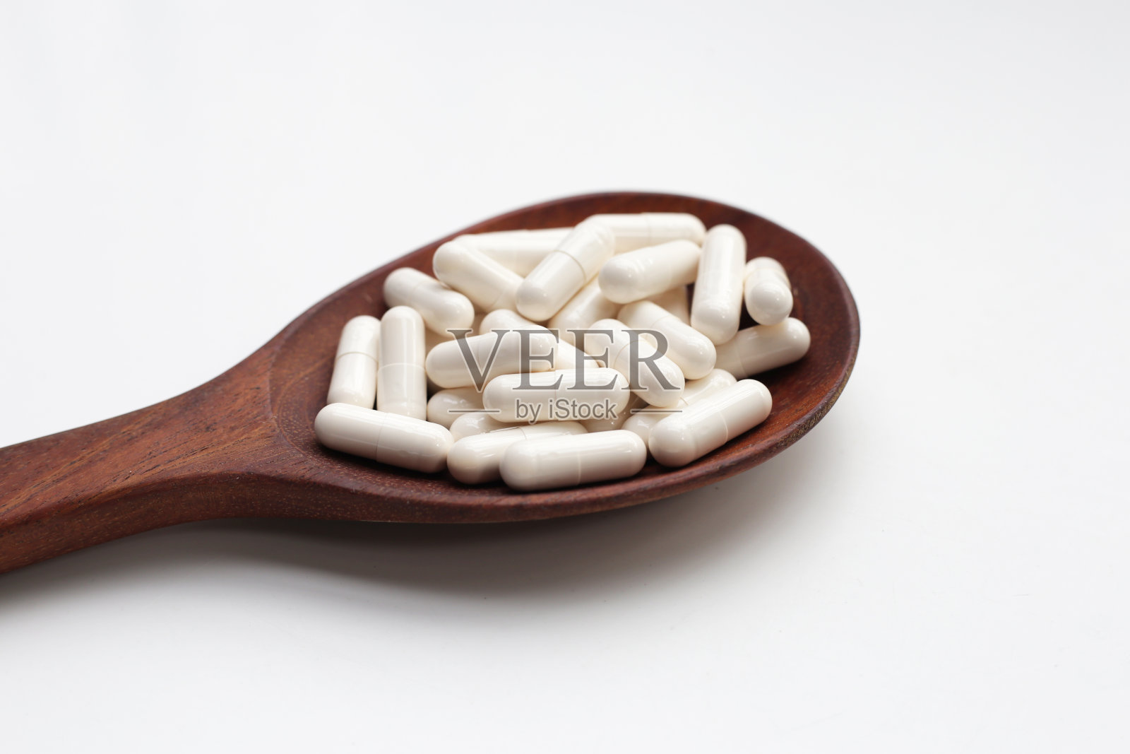 白底药胶囊。照片摄影图片