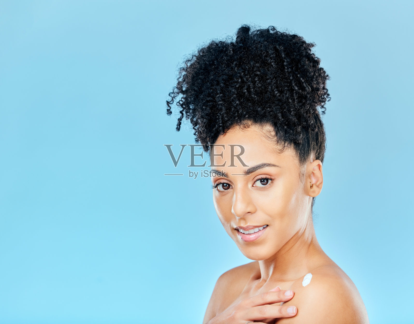 护肤,身体霜和女性肖像在工作室乳液应用在蓝色背景。面部、美容和女性健康模型使用防晒霜、润肤霜或皮肤科、化妆品或发光照片摄影图片