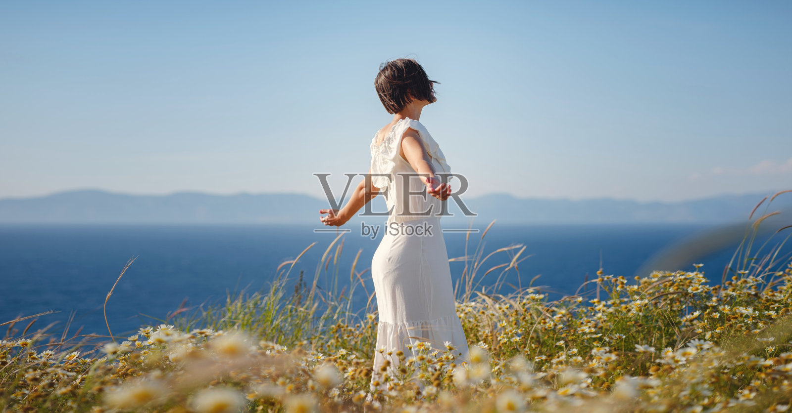 美丽的亚洲年轻女子在户外穿着白色连衣裙照片摄影图片