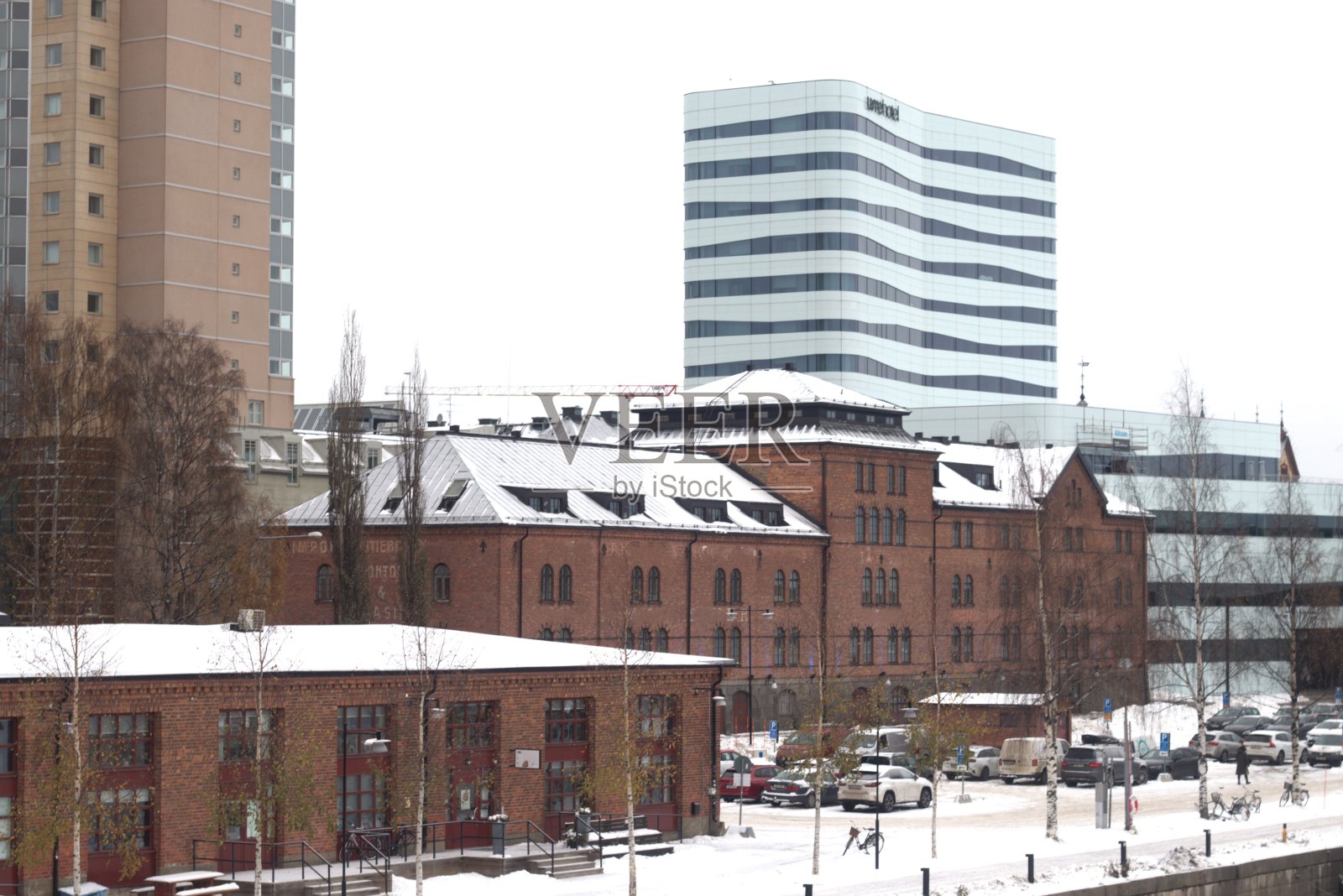 黑暗的城市里有路灯。尤梅夫市潮湿和下雪的街道。在瑞典北部寒冷的十一月,五彩缤纷的街道。照片摄影图片
