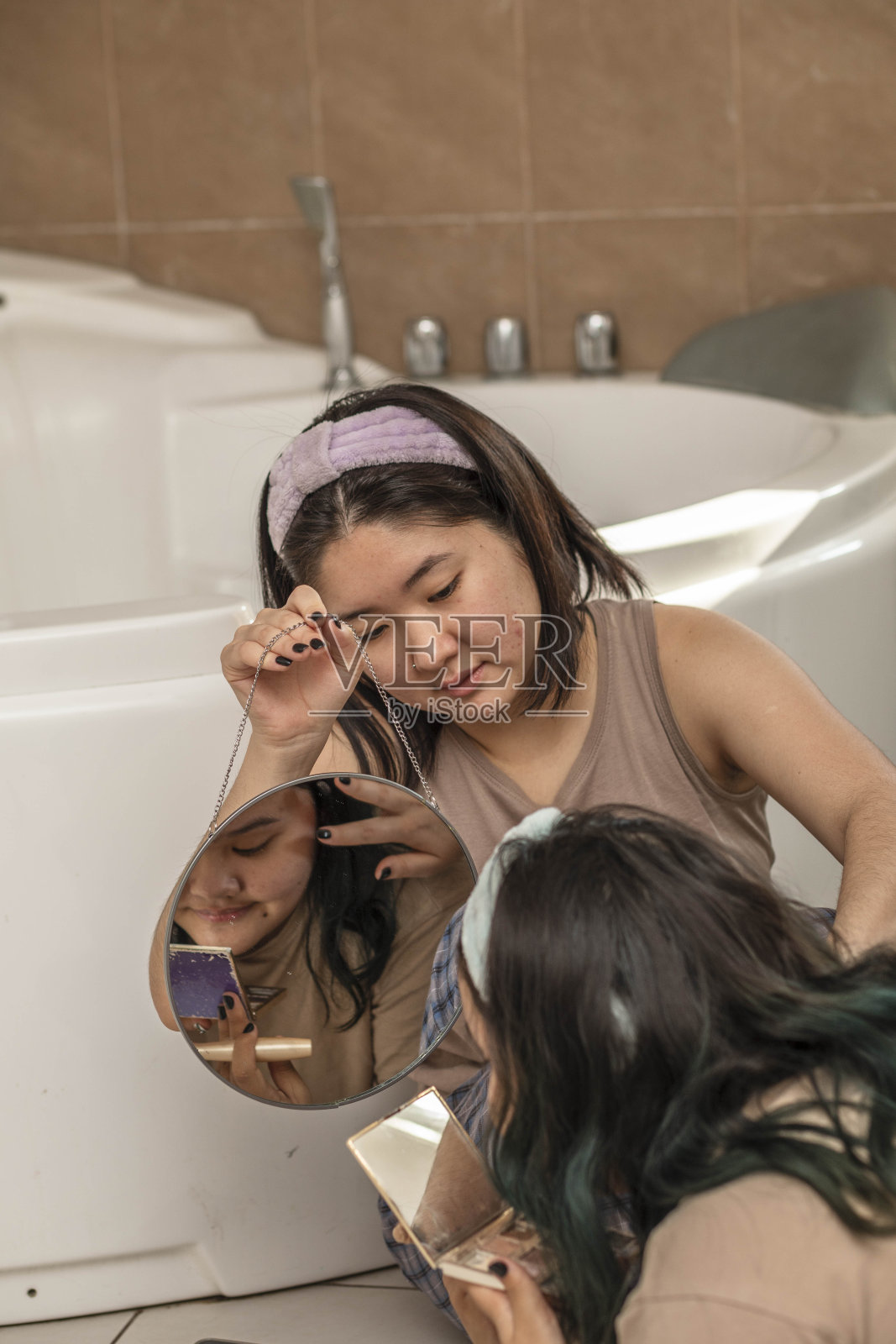 亚洲的美容青少年每天早上都会在浴室里对着镜子治疗痤疮。绿色的头发照片摄影图片