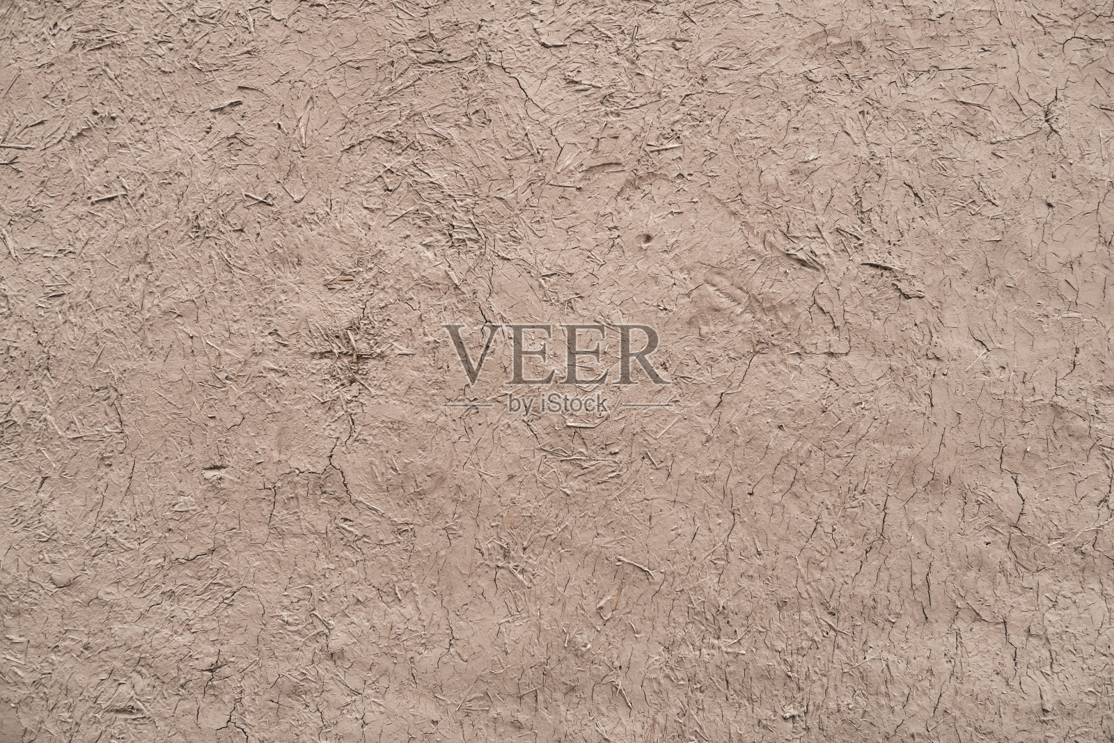 在Khorezm的Khiva古城,一座由稻草和粘土制成的古建筑立面上的外部石膏纹理照片摄影图片