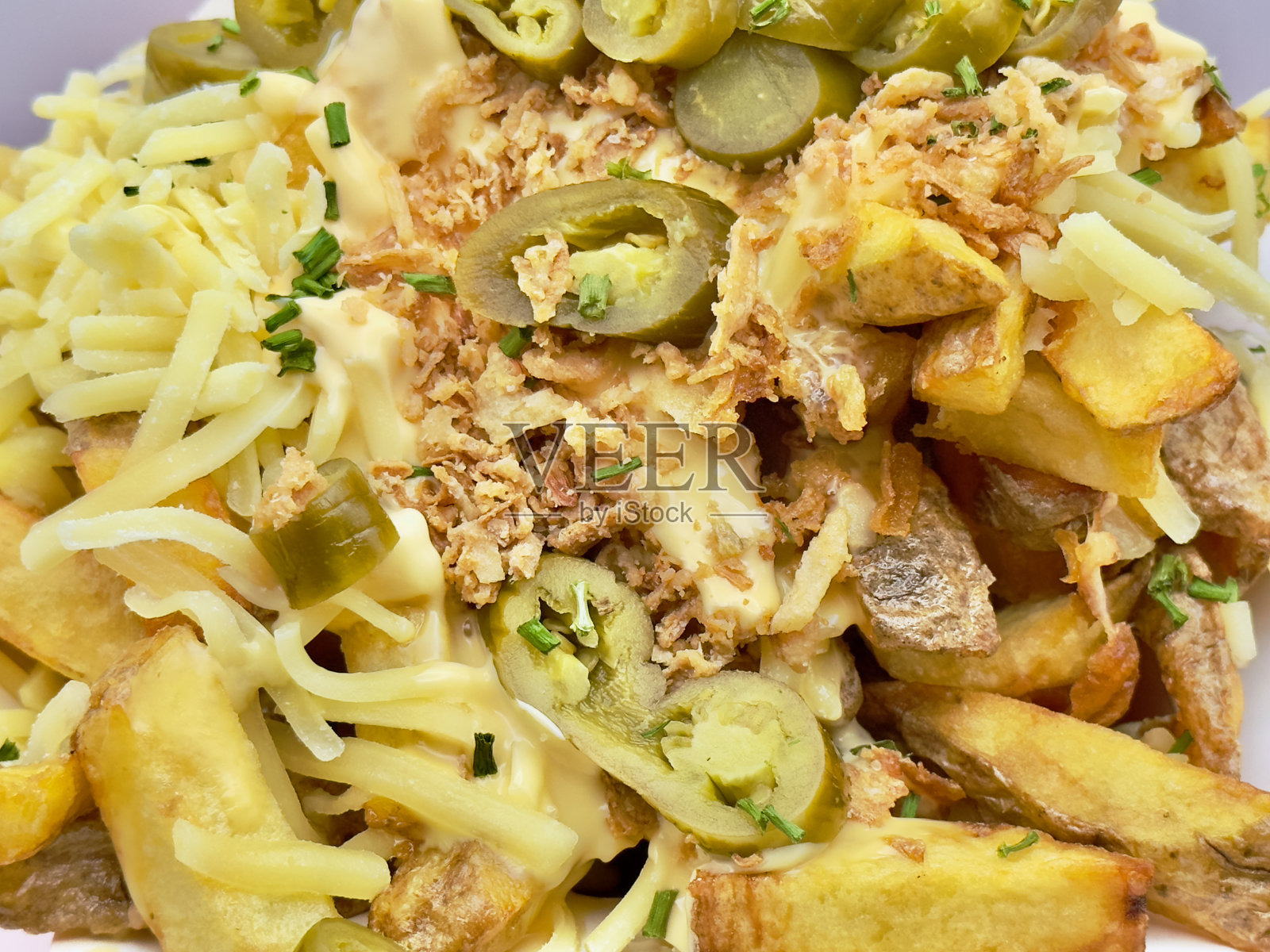 柳条篮子里装满了煮熟的土豆,上面覆盖着融化的奶酪照片摄影图片