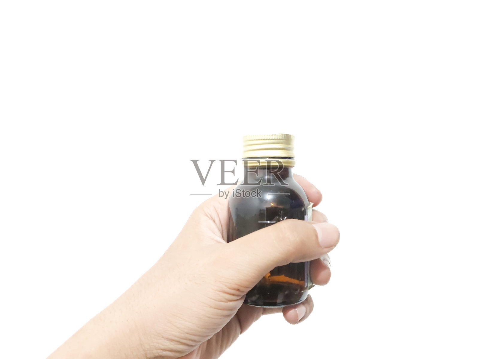 手指拿着或抓着一个白色背景的玻璃瓶照片摄影图片