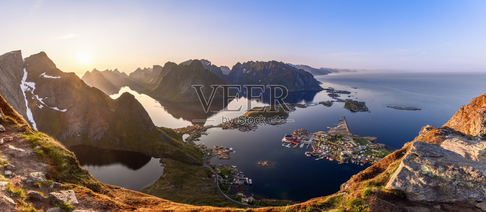 当午夜的太阳照亮天空时,从莱因布林根拍摄的广角超级全景显示了罗弗敦岛的辉煌,阳光普照的莱因村被镜子般的海水和锋利的山剪影包围照片摄影图片