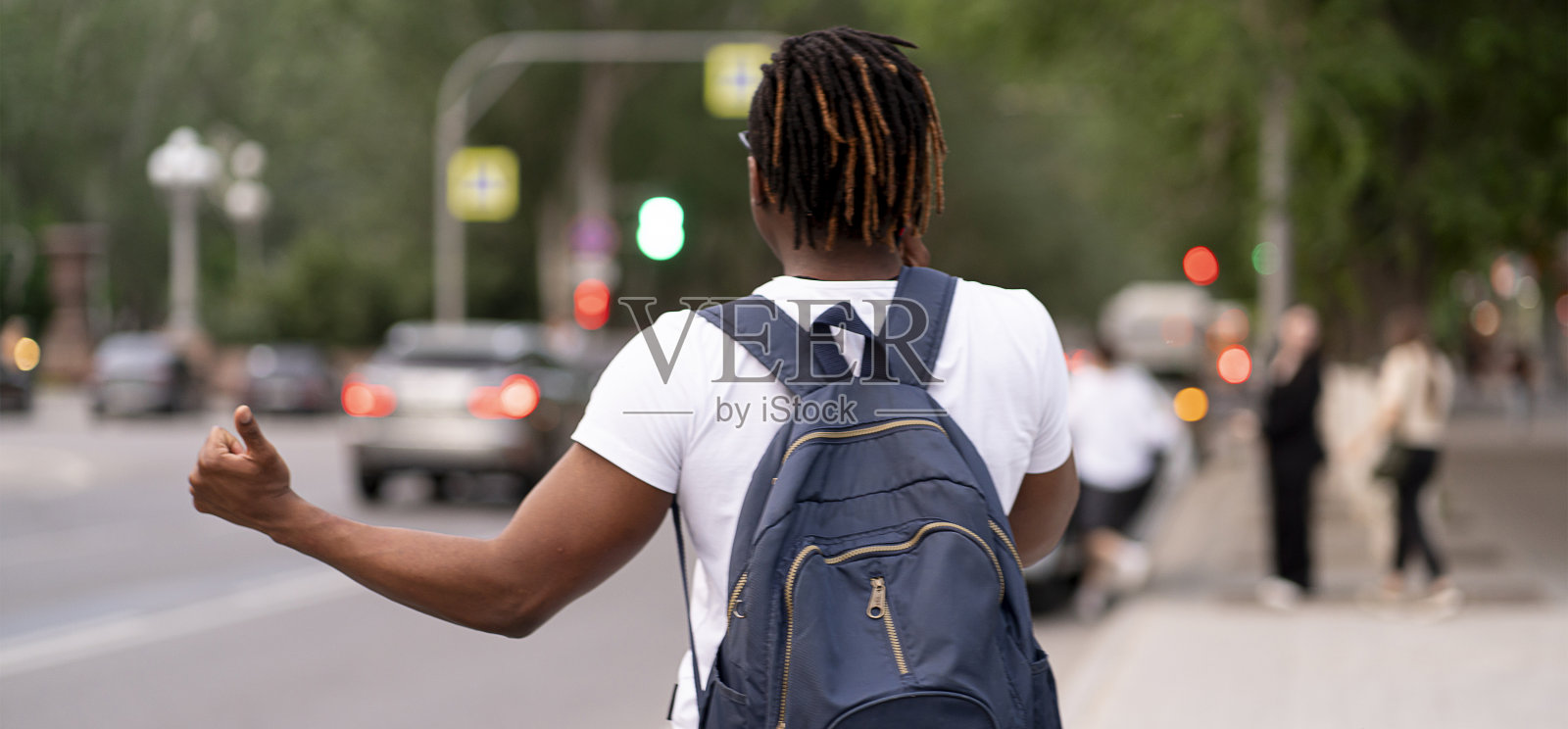 一个站在高速公路附近的人在城市里赶出租车照片摄影图片