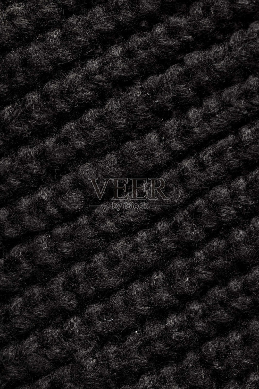 黑色针织织物作为抽象背景。纹理照片摄影图片