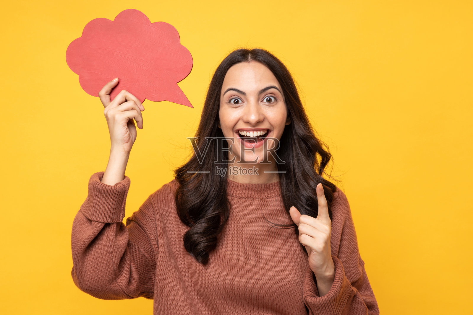 照片的年轻女子在冬天穿着抱着泡沫的思想孤立的黄色背景股票照片照片摄影图片