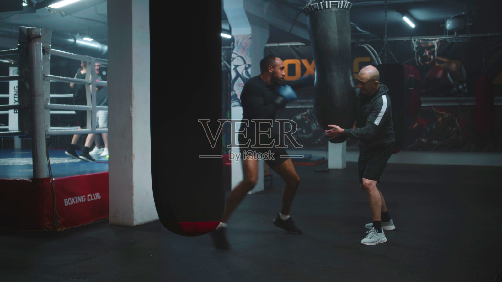 戴着拳击手套的非裔美国拳击手与教练一起练习照片摄影图片