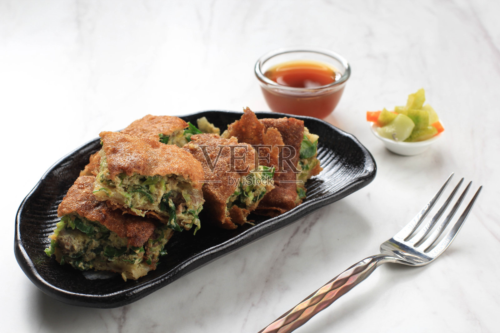 Martabak Telur是印尼很受欢迎的街头小吃。鸡蛋,葱,薄面糊包照片摄影图片