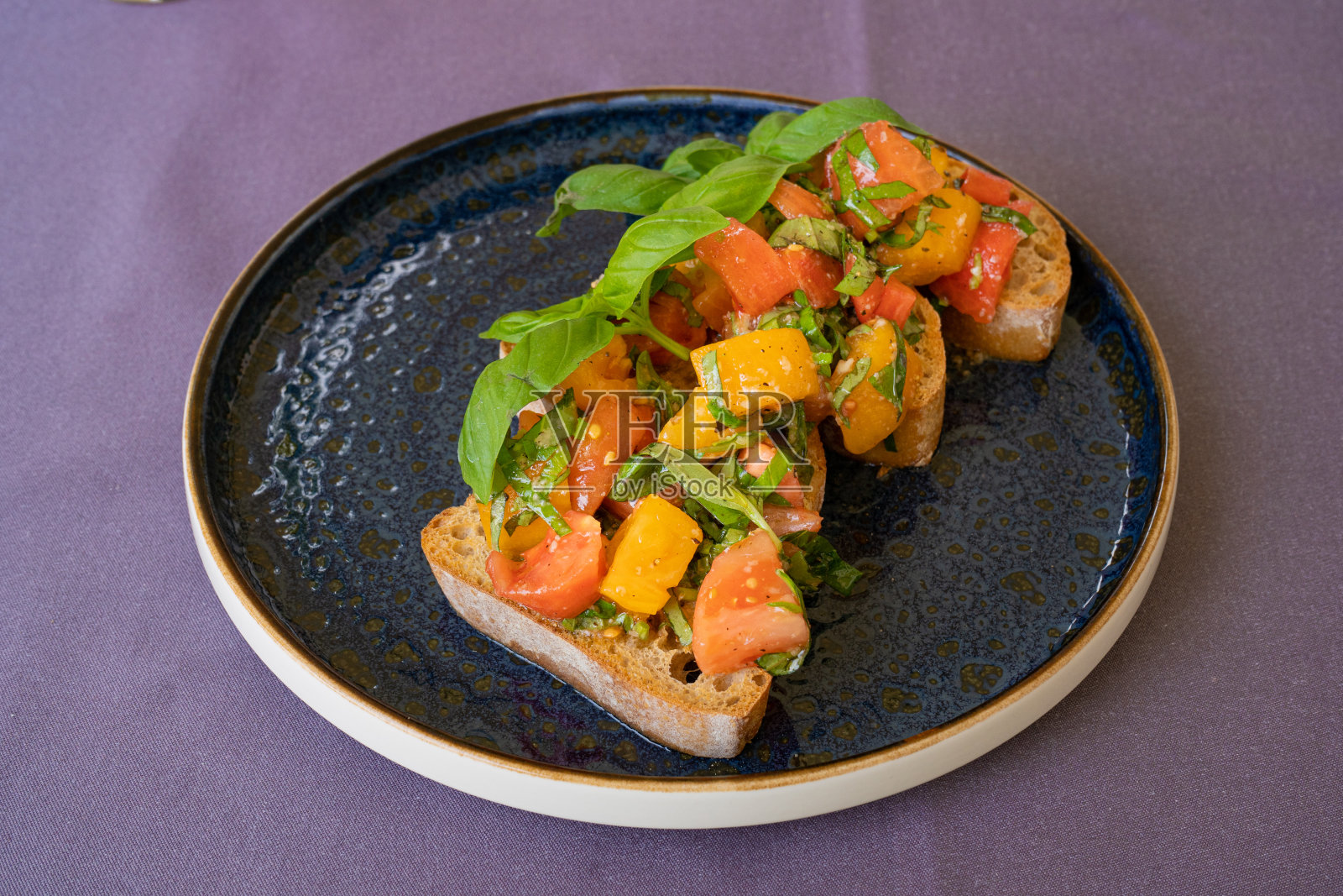 彩色烤面包,意大利法棍面包配红黄番茄,罗勒,健康地中海吐司照片摄影图片