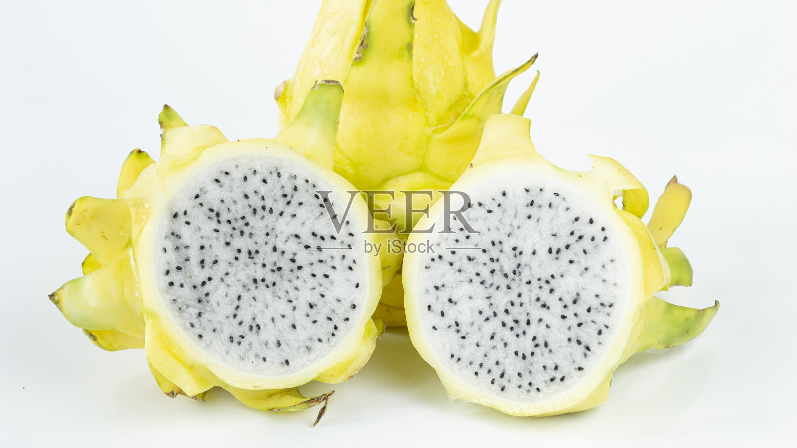 一个亮黄色的火龙果切成两半。照片摄影图片