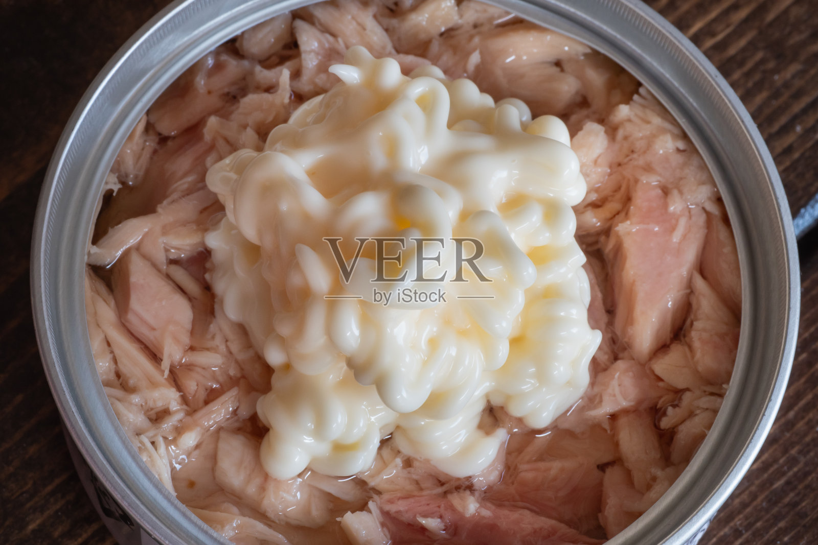 涂上蛋黄酱的金枪鱼罐头特写。照片摄影图片