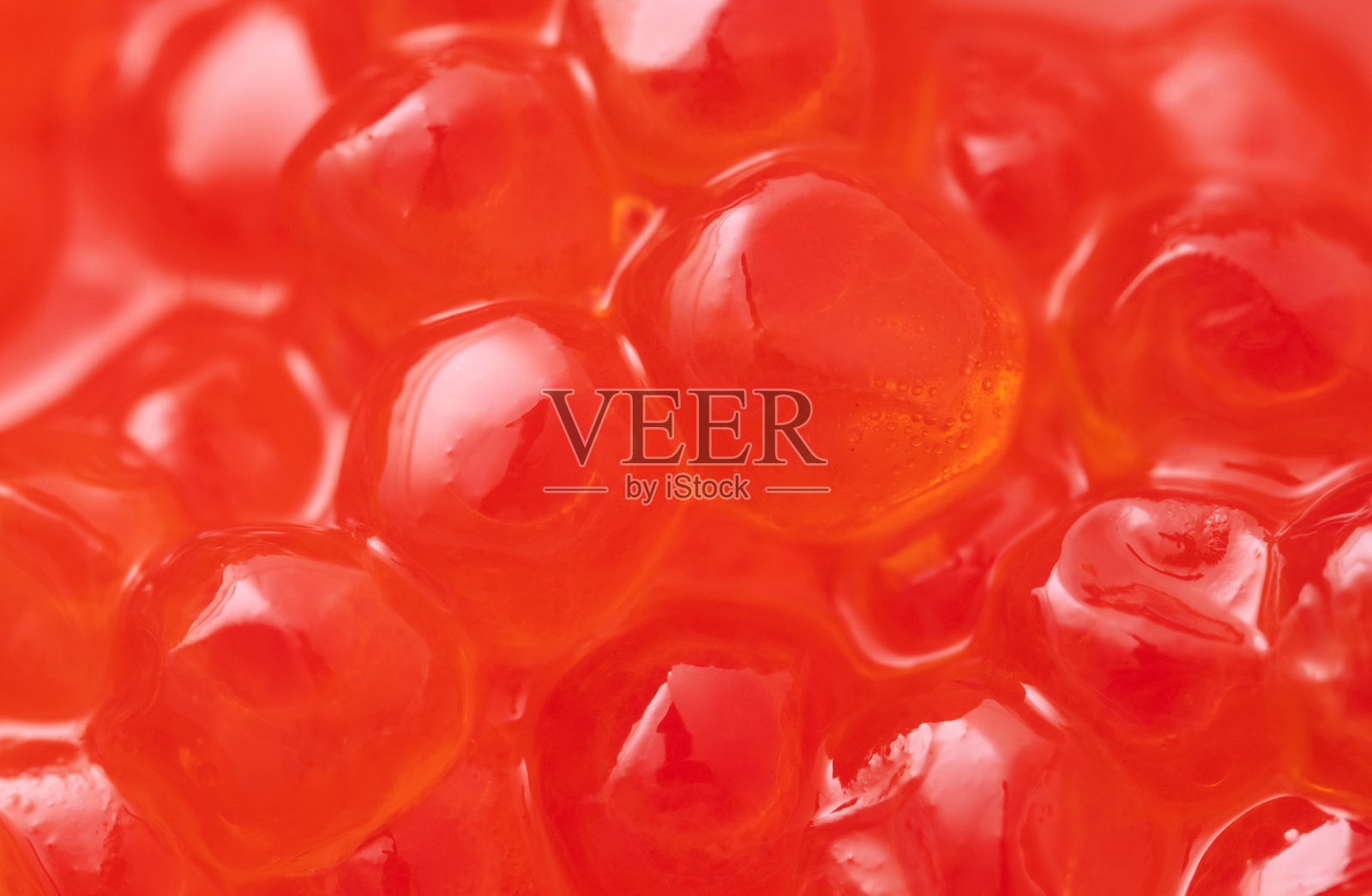 红鲑鱼鱼子酱作为背景。宏。照片摄影图片