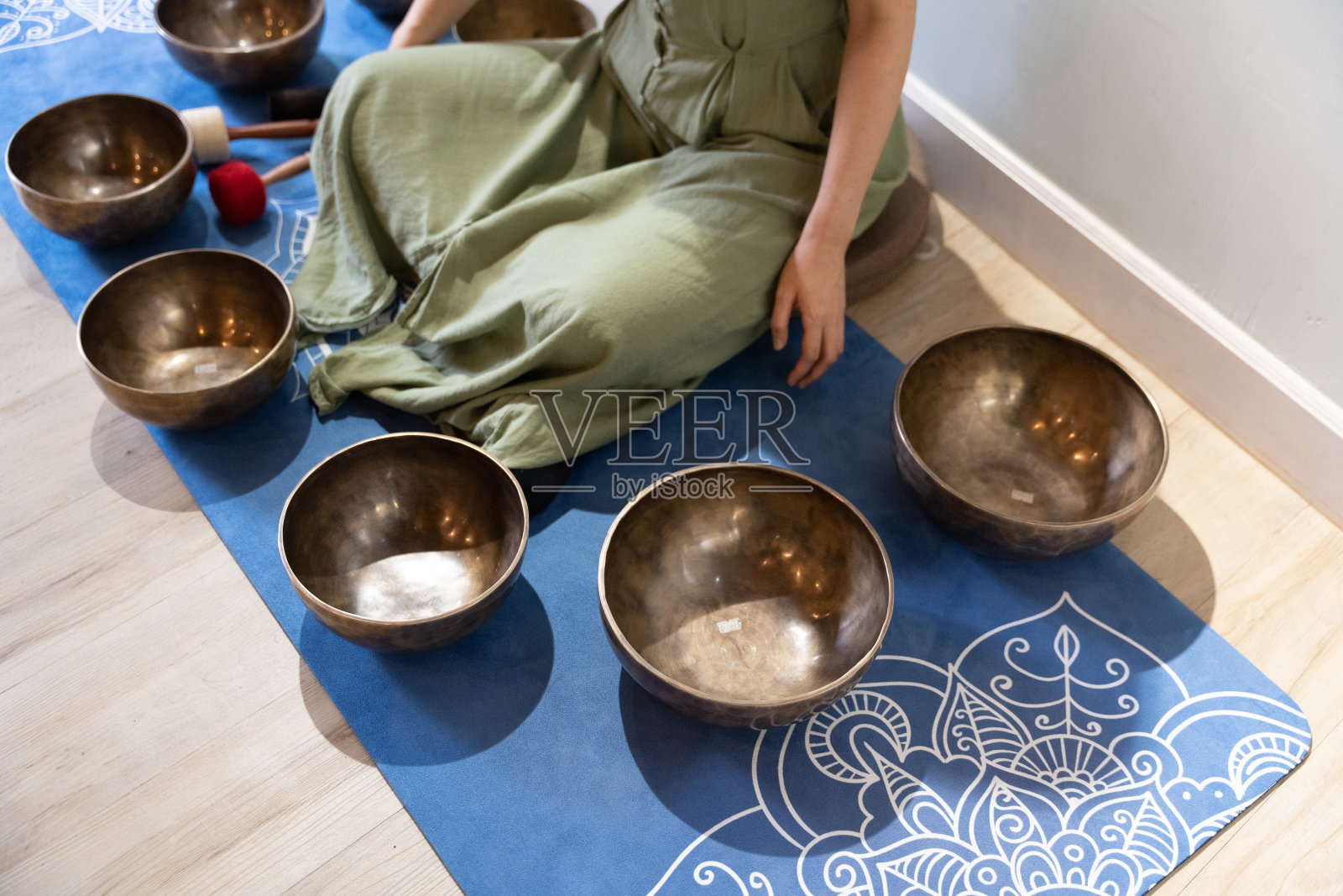 一个近距离的观点揭示了美丽的歌唱碗乐器设置在一个蓝色的垫子照片摄影图片