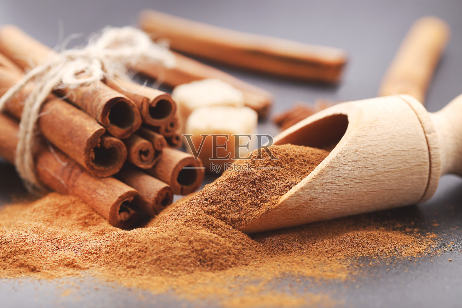 肉桂粉与棒和八角茴香在黑色背景照片摄影图片