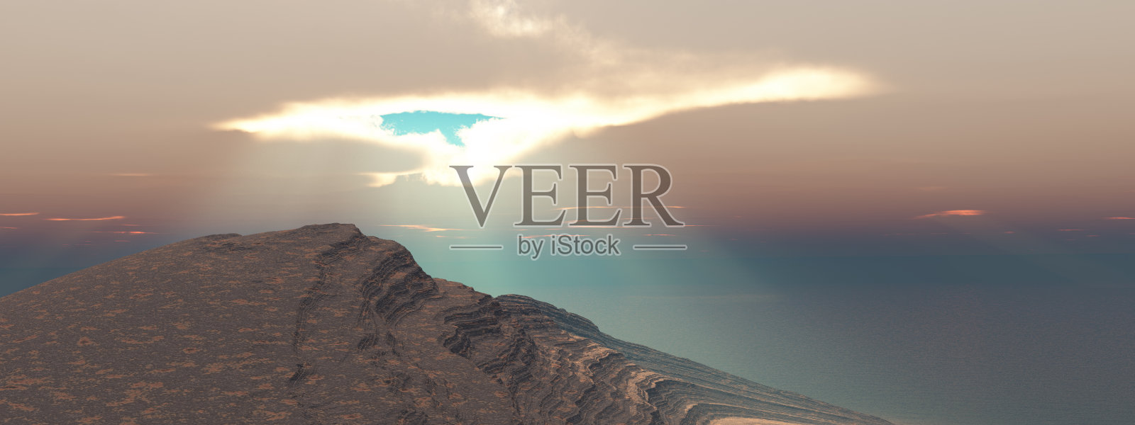 云层间的缝隙,阳光照耀着海岸的景色照片摄影图片