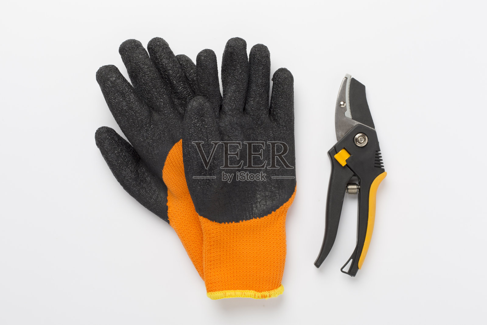 在彩色背景上带手套的剪枝机,顶部,视图照片摄影图片