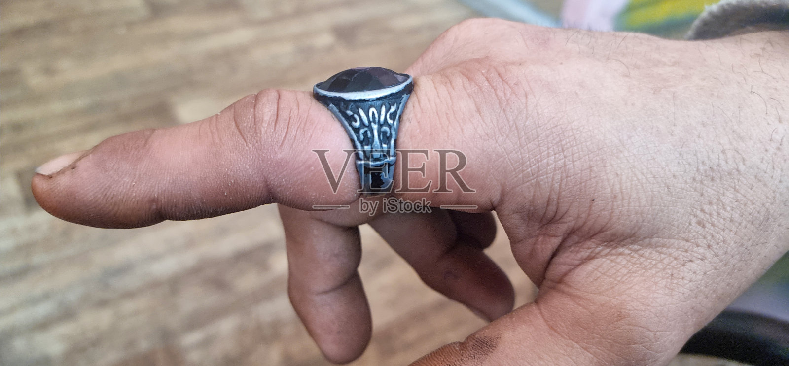 肿的手。从肿胀的手指上取下卡住的戒指照片摄影图片