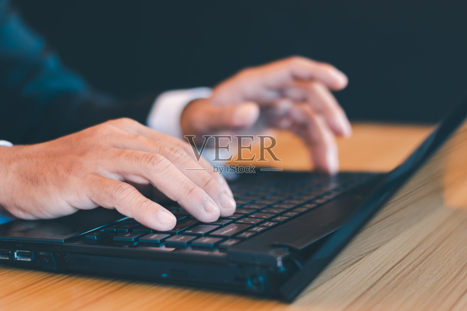 商人的手在办公桌上摆弄笔记本电脑照片摄影图片