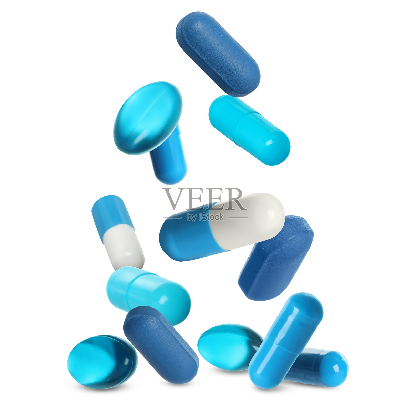 许多不同的药片落在白色的背景上照片摄影图片