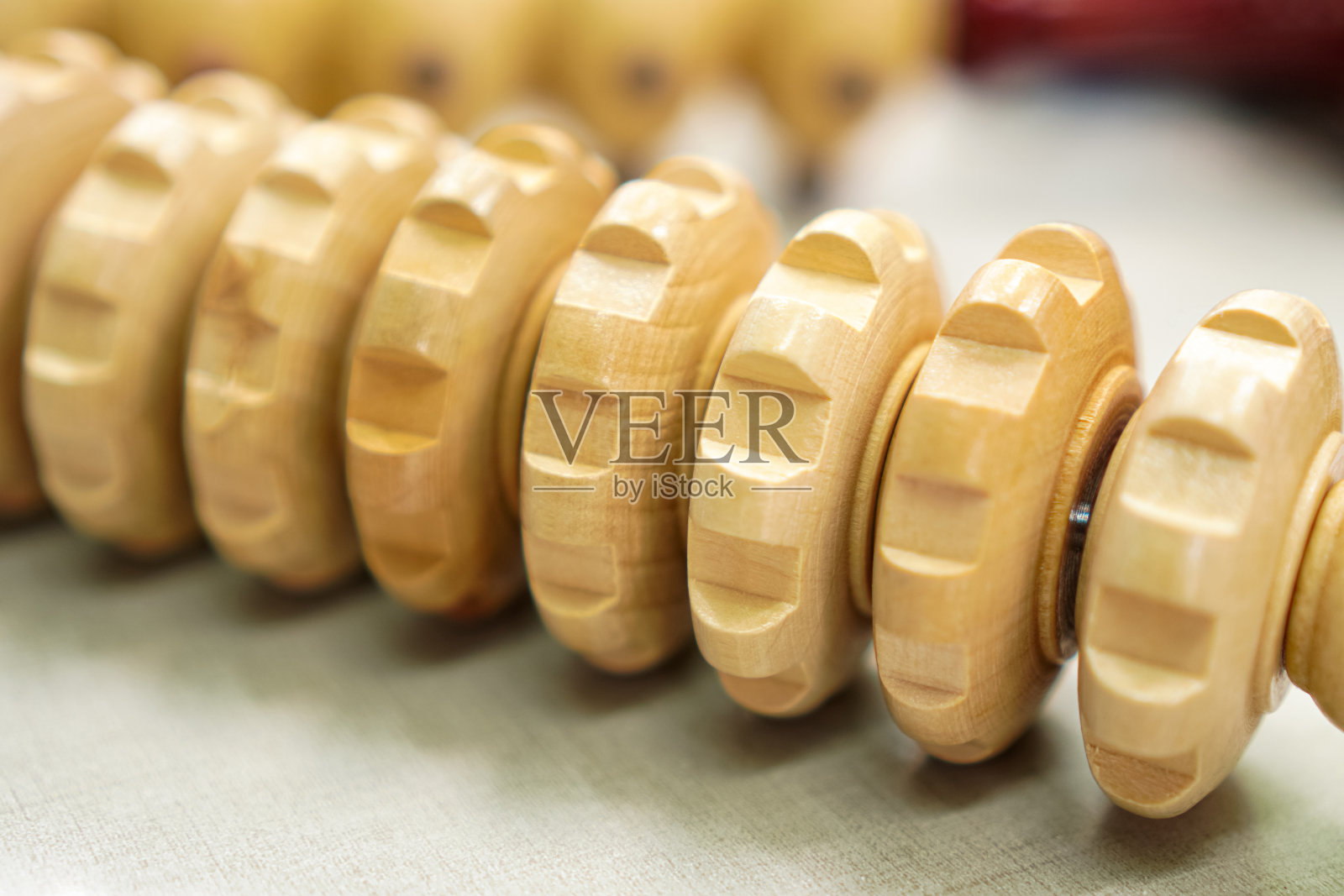 一个特别设计的按摩和伸展装置的特写,由硬木制成,可以轻松地在胳膊和腿上滚动。照片摄影图片