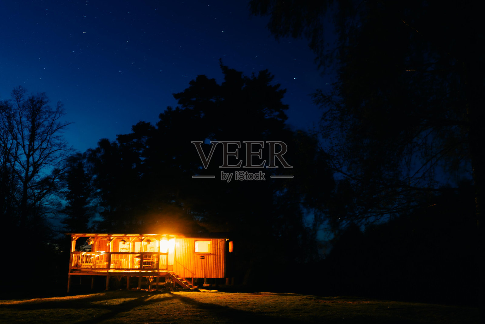 晚上带着灯笼,晚上在森林里的星空下,在山里的房车里照片摄影图片