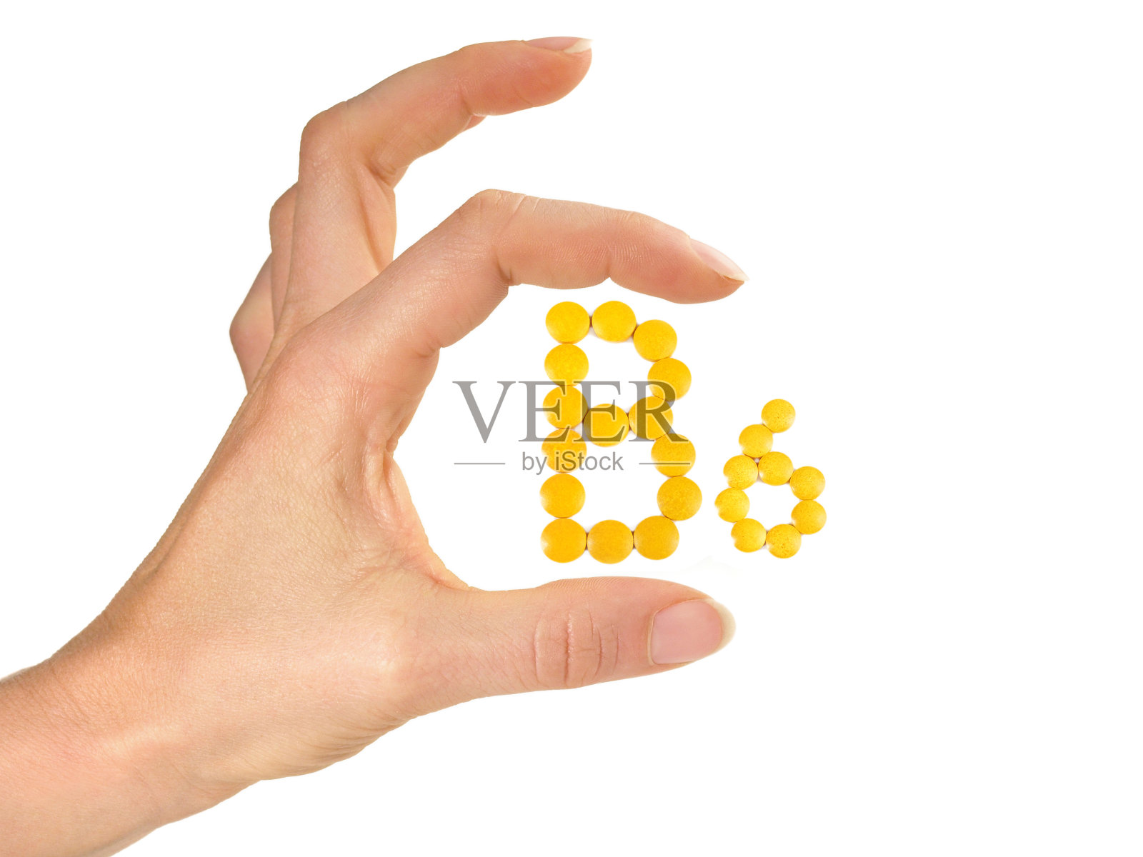 维生素B药片分离- B6在白色背景与妇女手照片摄影图片