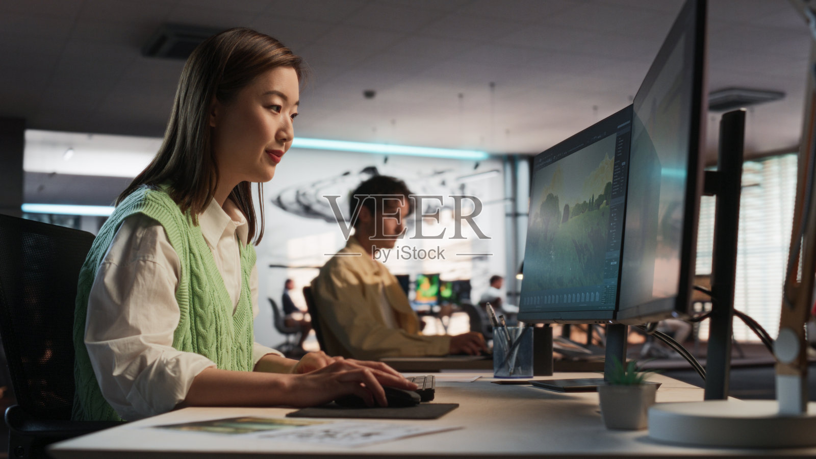 亚洲妇女使用台式电脑和设计在三维建模软件独特的世界和角色的生存电子游戏在不同的办公室。女性游戏开发者创造沉浸式游戏玩法照片摄影图片