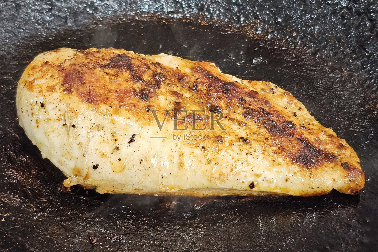 在锅里煎鸡胸肉照片摄影图片