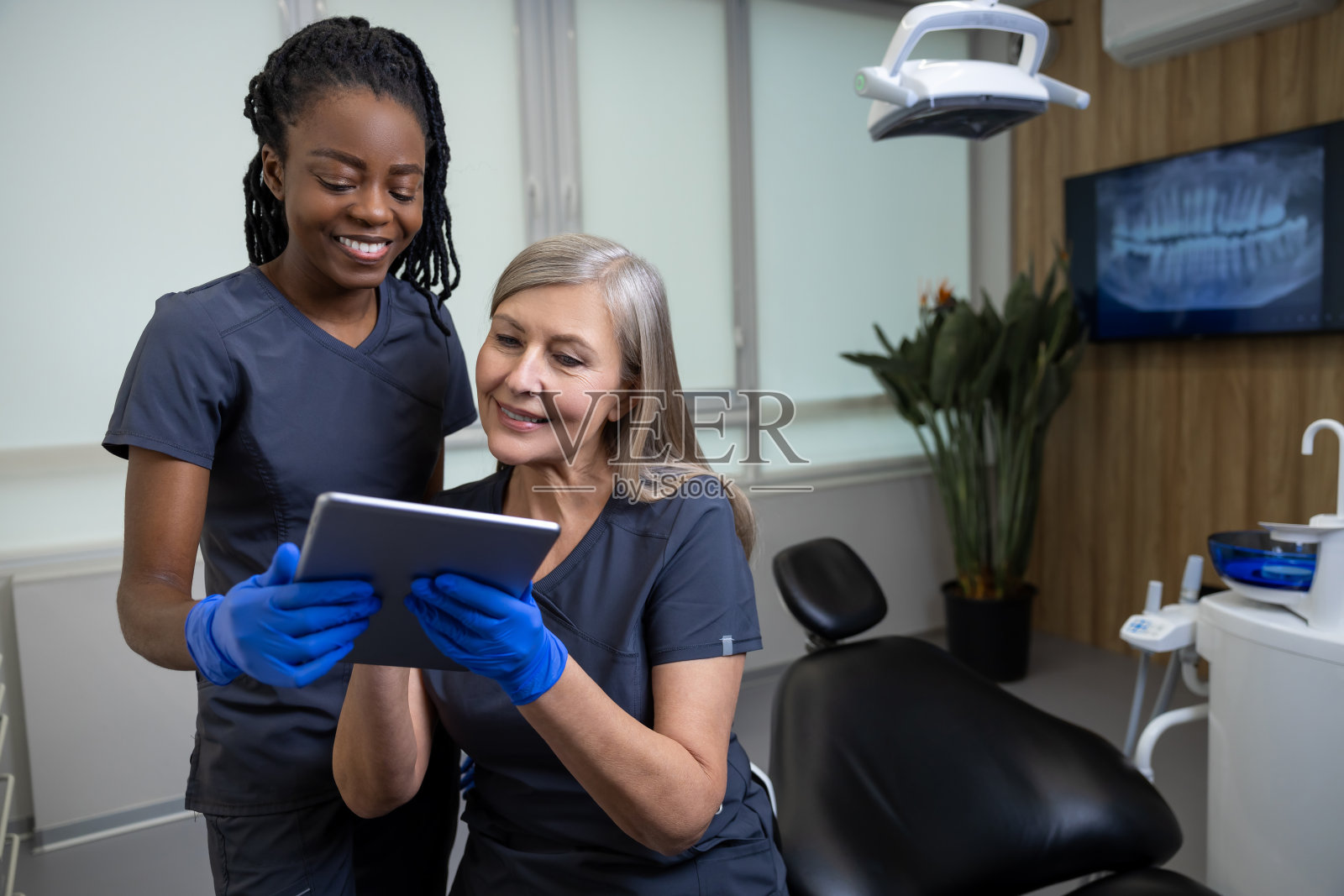 两位医生同事在诊所换班时讨论一些事情照片摄影图片