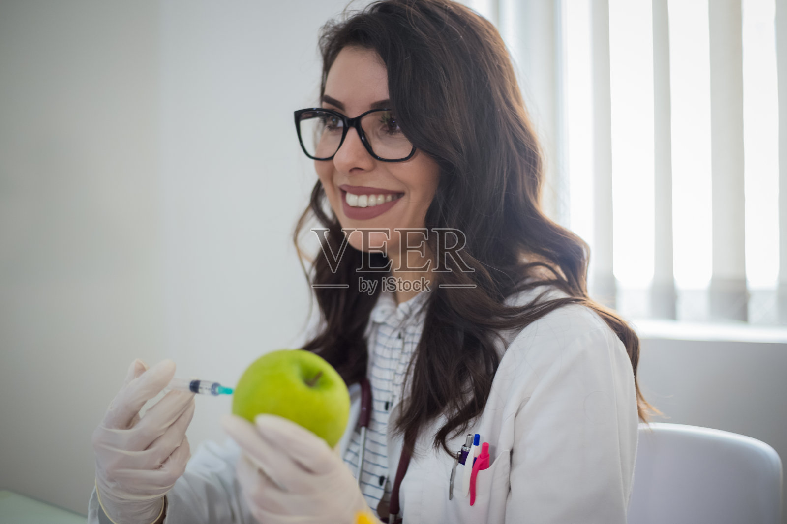 女医生用针头注射到绿色app照片摄影图片