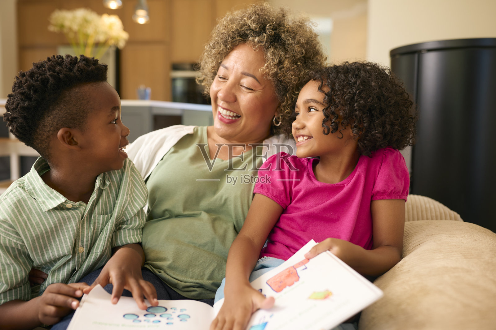 奶奶在家照顾孙子,一起读故事照片摄影图片