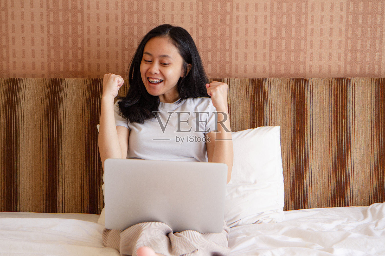 快乐的亚洲年轻女子在家用笔记本电脑照片摄影图片