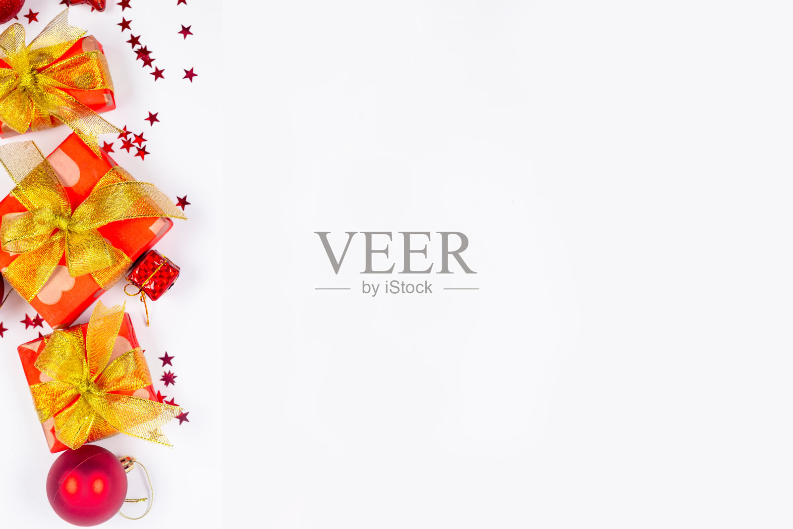 红色和金色的圣诞小玩意,白色背景的红色礼盒。圣诞贺卡快乐,照片摄影图片