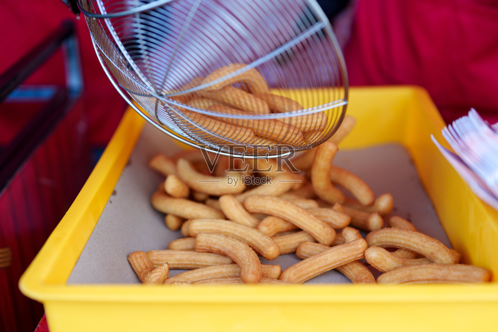 一堆刚炸好的油条放在冷却盘上,准备出售照片摄影图片