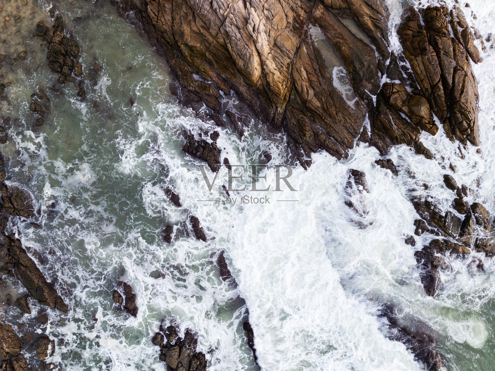 海浪撞击海岸岩石,俯视图海面波浪背景照片摄影图片