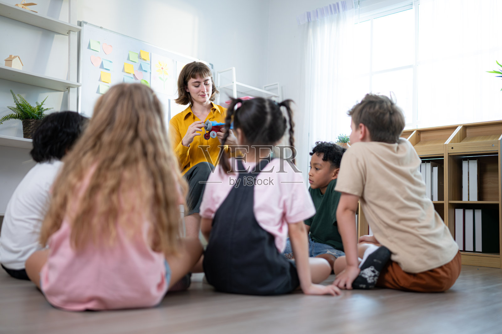 老师和学生们,在学校的教室里学习和研究飞机,孩子们坐在那里全神贯注地听着。照片摄影图片