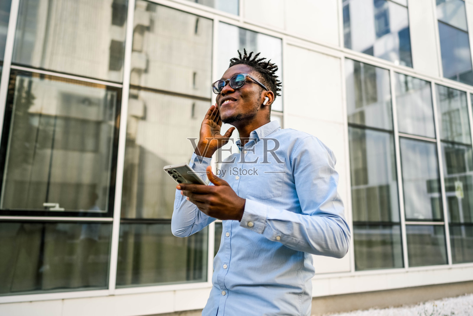 戴着无线耳机的人接到了一个来电照片摄影图片